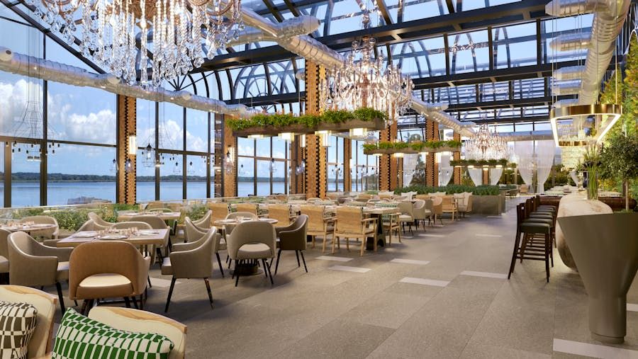 Bright upscale restaurant dining room with chandeliers, greenery and water views